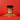 A bottle of Chili Crisp SaladSprinkles nestled in a little pile of salad sprinkles on a red background.