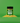 A bottle of Classic Herb SaladSprinkles nestled in a little pile of salad sprinkles on a green background.